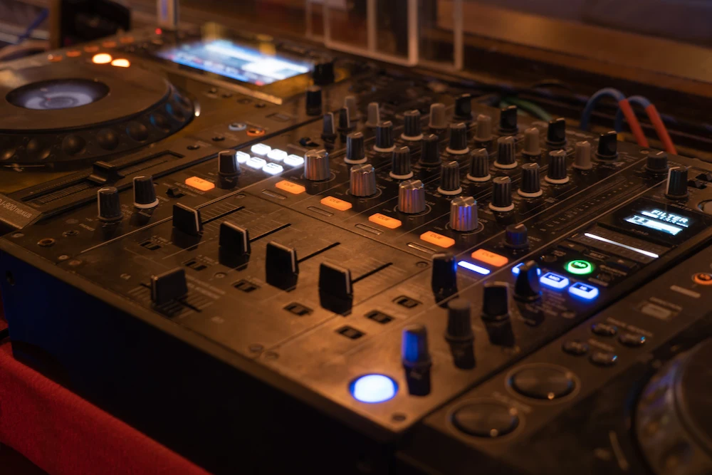 A dj mixer is sitting on a table.